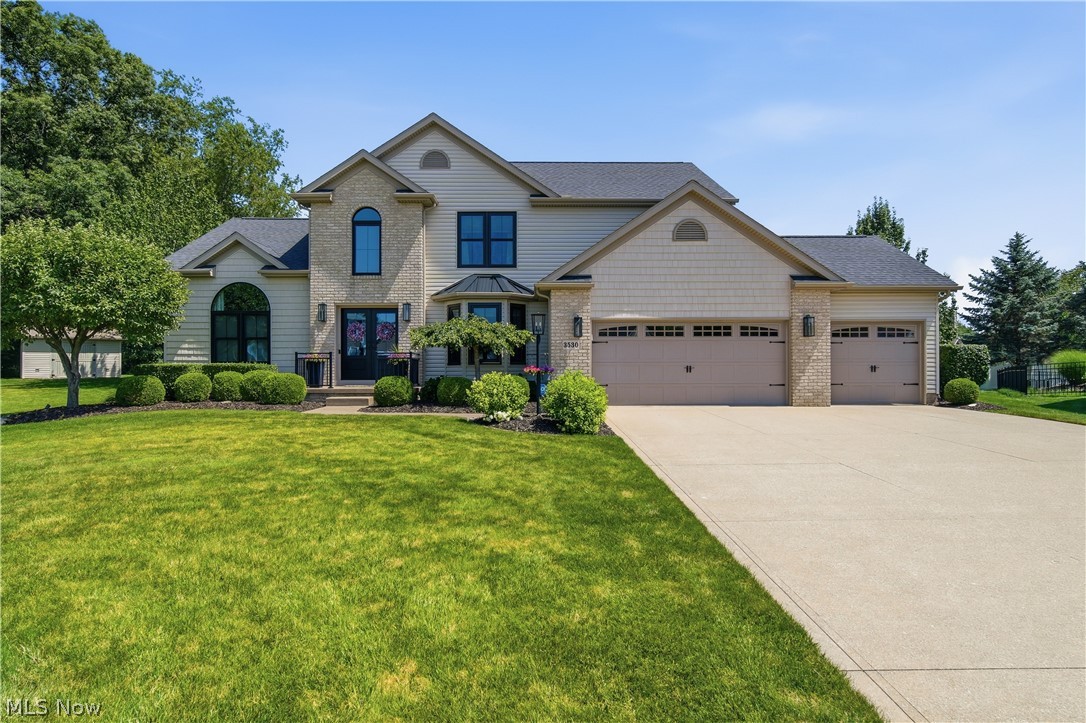 Tucked away at the end of a quiet cul-de-sac, this impeccably maintained 4-bedroom, 2 full and 2 half bath home offers over 2,300 square feet of beautifully designed living space, plus more than 900 finished square feet in the lower level. From the moment you arrive, you'll appreciate the pride of ownership, highlighted by new siding (2021), updated front doors (2020), and exceptional attention to detail throughout. The dream kitchen is truly the heart of the home, featuring an enormous granite island with seating for six, built-in storage, electrical outlets for everyday convenience, abundant cabinetry, and a charming walk-in pantry with frosted glass doors. Whether you're hosting holidays or enjoying a quiet morning coffee, this space was designed to bring everyone together. The dramatic great room showcases soaring vaulted ceilings and a cozy gas fireplace, while the adjoining sunroom fills the home with natural light and offers peaceful views of the backyard. Step outside to enjoy two patios—both finished with durable epoxy coatings—creating the perfect spaces for entertaining or unwinding. A main-level bedroom and half bath provide flexibility for guests, a home office, or multigenerational living. The finished lower level adds more than 900 square feet of additional living space along with another half bath, making it ideal for a recreation room, media room, fitness area, or playroom. Car enthusiasts and hobbyists will love the heated 3-car attached garage, complete with professionally finished epoxy floors. The home also features an irrigation system to keep the beautifully maintained lawn looking its best with ease. Every inch of this home reflects quality, care, and thoughtful updates, offering the perfect combination of style, comfort, and functionality in a highly desirable cul-de-sac setting.