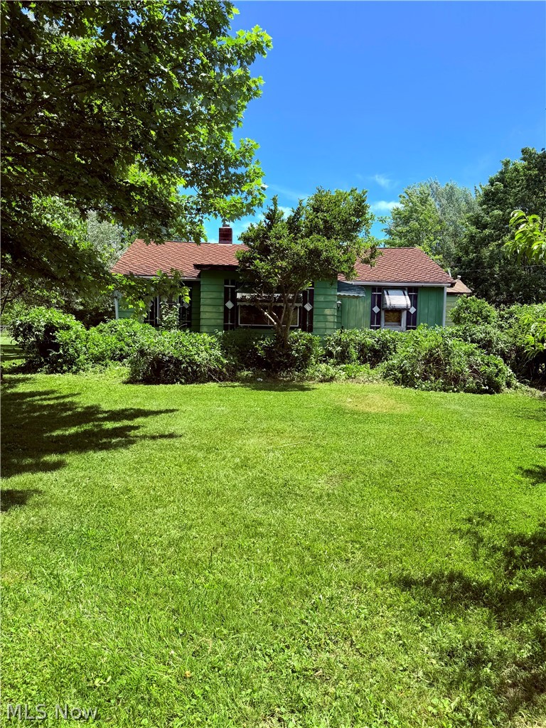 Looking for 5 acres of country paradise??   Here is your chance....a liveable, fixer upper house with a workshop/garage, concrete block shed/outbuilding  (with electric), and  an existing shooting  range with a back drop.   The big barn is a tear down, maybe you have the skills to rehab it, but the seller will not.  This is an AS IS sale.   However, roof is 12-15 years old, NEW electric tankless hot water system, and functioning electric furnace PLUS a wood burner system in the dry basement.  Enjoy the walnut trees, peach trees, blueberry bushes and grapes plus whatever else you wish to add.  200 amp electrical and the garage has 220 line.  Attic is insulated.  So, come on out and explore the endless potential to rehab, tear down and rebuild or even expand this ranch.  No wholesalers, no rent to own and no seller financing.  Contract the listing agent or your agent as this property is an excellent candidate for rehab loans and the listing agent has great lending options for USDA, VA and FHA buyers as well as cash or conventional.