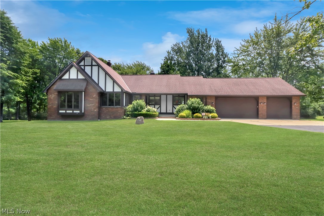 Welcome to this exceptional all-brick ranch with classic Tudor trim at 11785 Arbor Glen Drive in Chardon, Ohio. Set on two landscaped acres in an upscale subdivision within the Chardon Local School District, this custom-built home was originally the builder's personal residence and offers 3,916 sq ft of meticulously maintained living space.

The showstopper: a massive 24x30 detached, two-story pole barn, ideal for contractors, car enthusiasts, or hobbyists. It features its own driveway, dedicated electric and water with separate panel boxes, and three brand-new (2024) insulated commercial overhead doors. The home also offers an oversized three-car attached garage.

Inside, enjoy solid wood interior doors, central vacuum, and skylights throughout. The main level features a living room with an Arizona stone fireplace, a kitchen with granite counters, new Delta faucet, breakfast bar, newer appliances, and porcelain flooring. Three bedrooms and two full baths complete this level, including a primary suite with a skylight and new Pella door to the deck. The dining room offers hardwood floors, custom Roman shades, and its own walkout.

The finished walk-out lower level adds a large family room with a second Arizona stone fireplace and woodburning insert, a den with its own exterior entrance, a fourth bedroom, and a third full bath, plus ample closets and egress windows. In total, the home offers two fireplaces and an open split stairway connecting both levels.

Recent updates: new roof, high-efficiency furnace (2024), gas water heater (2025), new A/C (2023), new 6" gutters, replaced garage doors/openers, Velux skylights with custom blinds, and a $15,000 well motor, pressure tank & water conditioner replacement.

Relax on the enlarged composite deck with vinyl railings, or the lower patio bordered by Versa-Lok retaining walls, overlooking a peaceful backyard with a scenic creek. A security system adds peace of mind. Schedule your private showing today!