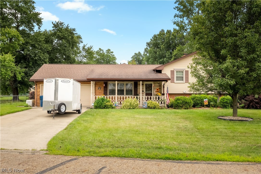 Welcome to this well-maintained split-level home located in the Marlington School District, offering a functional layout, updated living spaces, and exceptional outdoor amenities. The exterior features a paved circular driveway, a detached two-car garage, and a separate workshop that provides excellent space for hobbies, projects, or additional storage. The fenced backyard offers plenty of room for outdoor activities and includes two Trex decks, creating multiple spaces to relax or entertain.

Inside, the front entry opens to a spacious living room that flows into the updated kitchen and dining area. At the rear of the home, a bright family room with an abundance of windows fills the space with natural light and overlooks the backyard.

Upstairs, you'll find three generously sized bedrooms and a fully remodeled full bathroom. The lower level features an additional fully remodeled full bathroom, a laundry room, and a spacious room currently being used as the primary bedroom. This level also includes a fireplace and walkout access to the backyard, providing flexible living space to fit a variety of needs.

Offering numerous updates, ample indoor and outdoor living space, and a desirable location, this home is ready for its next owner. Schedule your private showing today.