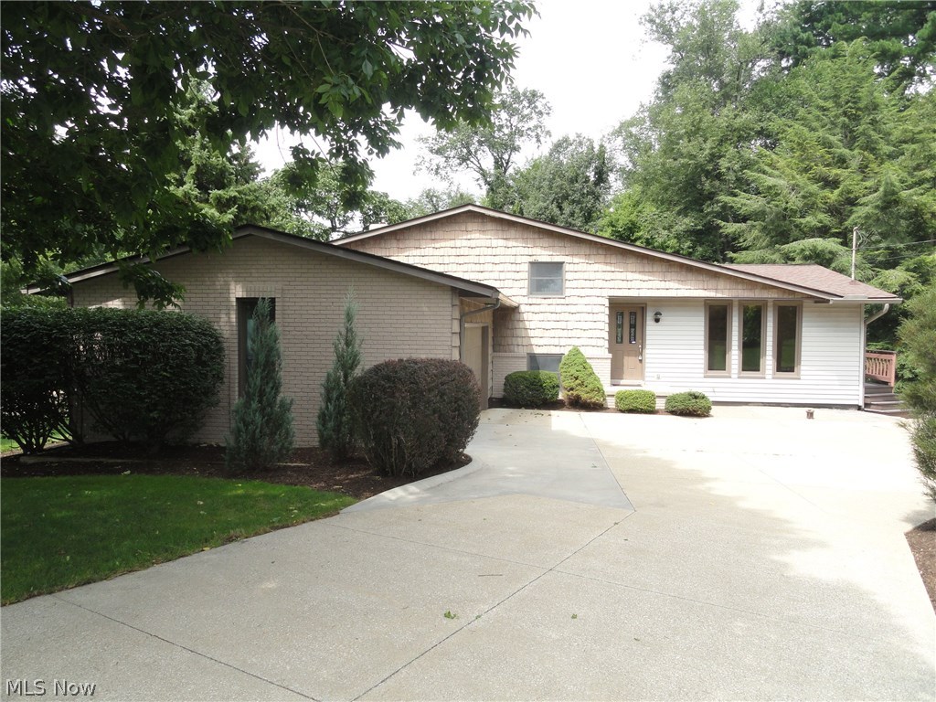 This impressive Twin Lakes 4 level split is uniquely designed and accented with custom woodwork throughout that includes trim, cabinets, shelves, beveled glass doors and beautiful wood and ceramic floors throughout. Warm and inviting with neutral décor. Spacious formal living room, beautifully modernized  eat in kitchen with sliding doors  in the dining area that lead to the expansive two tiered deck overlooking the  semi-private yard and wooded area. Lower level family room with wood burning fireplace, built in shelves  and a sliding door to lower level deck. 3 bedrooms 2 full  bath plus a bonus room that could be an office or work out room or even a 4th bedroom and there is a walk out basement too! Gas powered back up generator system in place. This home is  situated in the  Twin Lakes community which  includes lake privileges with a beach and dock for swimming , boating and fishing. Must see to appreciate, call today!
