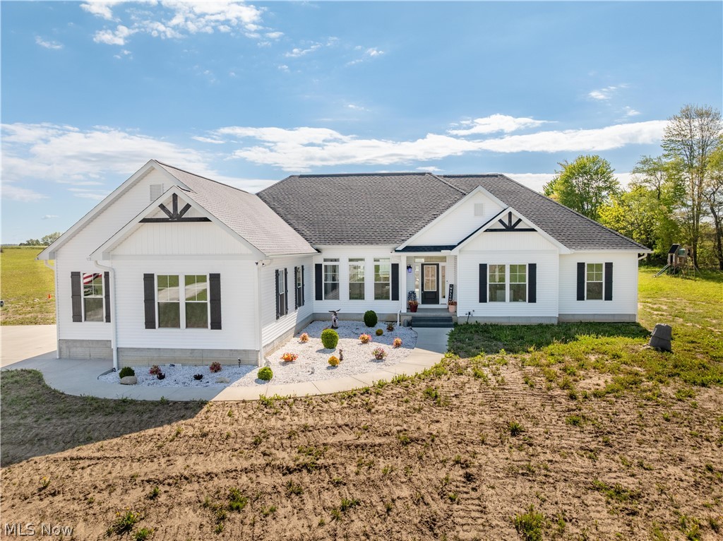 A private retreat with room to live, work, entertain, and unwind — this remarkable 2023 custom ranch is on 5.76 acres with gorgeous views in every direction. The setting offers peace and privacy so many buyers dream of. Inside, 2,757 sq. ft. of thoughtfully designed living space welcomes you with an open-concept layout featuring a spectacular eat-in kitchen flowing seamlessly into the spacious living and dining areas. A dedicated office provides the ideal work-from-home setup.

The exceptional floor plan features 4 bedrooms, including a serene owner’s suite, private junior suite, and two additional bedrooms connected by a Jack & Jill bath. Main floor pantry and laundry add everyday convenience. Accessibility features include a ramp, stair lift to the basement, and wired generator for added peace of mind.

Step outside to the expansive composite deck overlooking the peaceful setting — perfect for hosting gatherings or simply enjoying the beauty of nature. In addition to the attached garage, the property boasts an impressive 46x30 pole barn and extra detached garage for endless storage, hobbies, or workspace possibilities. Located in Tuslaw Local School District, this is a rare opportunity to own an exceptional property that offers space, style, and unmatched versatility.