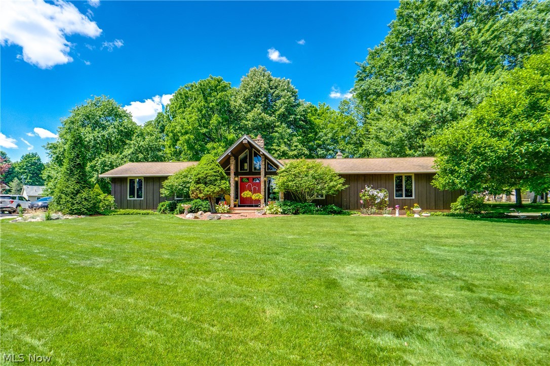 Welcome to Your Entertainers' Paradise! This beautifully updated three-bedroom, three-bath ranch home in the desirable Louisville City School District is a dream come true for those who love to entertain. The inviting foyer welcomes you with vinyl plank flooring that flows throughout the first floor. The heart of the home is the stunning remodeled kitchen, featuring white cabinetry with soft-close doors, granite countertops, tile backsplash, and a large pantry. Plus newer stainless steel appliances (2022) and a garbage disposal. The open-concept design connects seamlessly to the dining area. The cozy family room showcases a floor-to-ceiling gas fireplace. Glass sliders open to an incredible outdoor entertainment space—two oversized decks with a large entertaining area and a patio with a fire pit, plus a private backyard, making it perfect for hosting summer cookouts. Three wonderfully sized bedrooms all offer California closets. The primary bedroom features its own private bath with a shower, vinyl flooring, and a single vanity. The main updated bath boasts a shower/tub combo and a granite-topped oak vanity. The finished basement is an entertainer's dream, complete with a second kitchen, a wet bar with a beautiful Birdseye maple countertop, and a full bath with cultured tile and a heat lamp. The spacious rec area features Berber carpeting, a cozy fireplace, and built-in shelving. The unfinished parts provide you with a work area with workbenches and storage. Don't miss your chance to see this wonderful home; schedule your showing today!