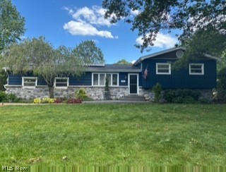 Welcome to this spacious and beautifully maintained split-level home tucked away on a quiet dead-end street in Tallmadge! Offering 5 bedrooms and 2.5 bathrooms, this home provides plenty of space for comfortable living and entertaining.

Inside, you'll find a large great room, a cozy family room featuring a wood-burning fireplace, and a walkout basement that adds both convenience and versatility. Thoughtful updates and amenities throughout make this home truly move-in ready.

Step outside and enjoy the meticulously landscaped yard designed for relaxation and entertaining. The fully fenced backyard features a stamped concrete patio, low-maintenance Trex decking, an included gazebo/canopy with netting, a fire pit, and a lighted bocce ball court. A storage shed with electric and attached chicken coop offers endless possibilities, including use as a kennel, garden enclosure, or hobby space. Water and electric service are available at both the house and rear of the property, along with roofline electrical outlets perfect for decorative patio or landscape lighting.

Additional highlights include a security light in the backyard, a newer roof, and solar panels that help reduce utility costs.

Car enthusiasts, hobbyists, and DIYers will love the attached 2-car garage featuring epoxy floors, a gas heater, hot and cold water, 220-volt power, an air compressor, extensive wall cabinetry, and overhead storage racks.

This exceptional property combines space, functionality, and outdoor living in a desirable location. Don't miss the opportunity to make this Tallmadge gem your next home!