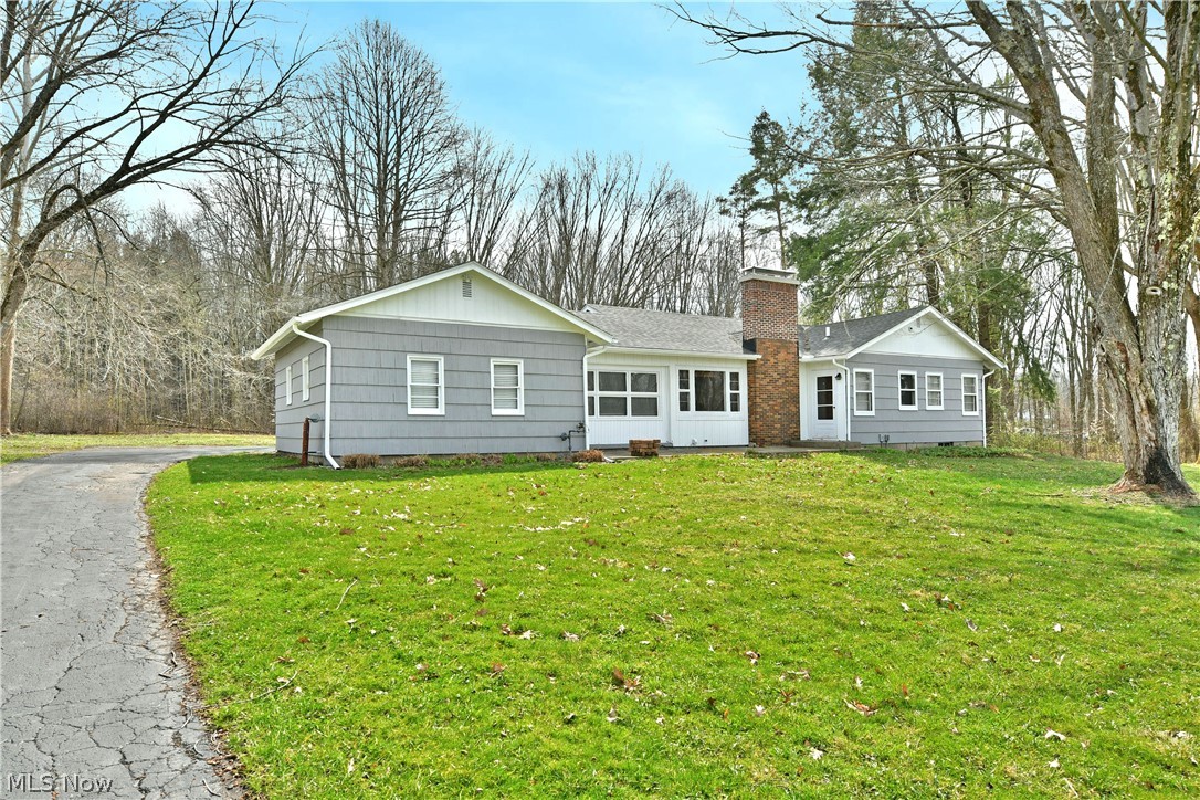 On the hunt for space, style and a move-in-ready package? Look no further than this beautiful Cortland ranch, packed full of tasteful updates and showcasing two floors of finished living space within its sprawling layout. Set far off the road and veiled by a bevy of tall trees, this home provides plenty of natural privacy with a fantastic backyard complete with a large firepit. A blacktop drive wraps around to find the two-car attached, rear entry garage. Separating the living space is a welcoming finished breezeway, perfect for lounging or four-season entertaining. Through the formal entrance, a breathtaking great room layout filled with wood paneled walls and gorgeous stone fireplace taking center stage. The sculpted walls sweep around to find both formal dining and the finished basement entrance. Around the corner, a brightly lit kitchen is sun washed with high contrast countertops and cabinetry, all complimented by a sleek, tiled backsplash. Eat-in dining space is available for casual meals. Opposite the living room, a short hall bridges the pair of spacious bedrooms. Joining them is a must-see full bath with an elaborate, walk-in shower and raised basin sink that feels right at home with the modern décor. Downstairs, an expansive family room finds both a corner bar area and a second, half bath. Laundry and storage are hidden away, respectively. **FREE GAS**