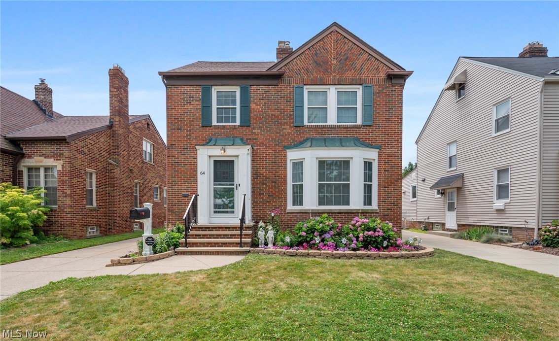 Welcome to 64 E 216th St! Timeless curb appeal defines this classic brick Colonial, where the landscaped front yard, welcoming entry, and elegant architectural details create an unforgettable first impression. Located in the desirable Beach Club community, residents have the option membership to enjoy year-round activities, a pavilion, picnic area, playground, and breathtaking Lake Erie sunsets. Step inside the foyer and into a spacious living room featuring a large bay window that fills the space with natural light and a beautiful fireplace. The formal dining room showcases crown molding, decorative wainscoting, an original built-in china cabinet, and a graceful arched opening to the living room, making it perfect for everyday dining and entertaining. The beautifully updated kitchen showcases ceiling-height two-tone cabinetry, elegant light-toned countertops, a designer tile backsplash, stainless steel appliances, and abundant storage and prep space. Just off the dining room, a bonus room is ideal for a home office, TV room, or playroom. The second floor offers three spacious bedrooms and a full bath. The third floor features a generous room with a lofted ceiling, perfect as a private retreat, guest suite, or flex space. The finished lower level adds even more living space with a large recreation room featuring a wood-burning fireplace, plus a half bath, laundry area, and plenty of storage. Relax in the beautifully landscaped, partially fenced backyard with a fire pit, perfect for summer evenings. A detached two-car garage adds convenience. Recent updates include new basement and bathroom flooring (2026); kitchen remodel and new living and dining room flooring (2025); new carpet in the bonus room, refinished staircase and upstairs hallway, basement painting and paneling (2024); new windows, roof, deck, second-floor bath remodel, and glass block basement windows (2023); and A/C (2019). Home is POS compliant. Schedule your private showing today!