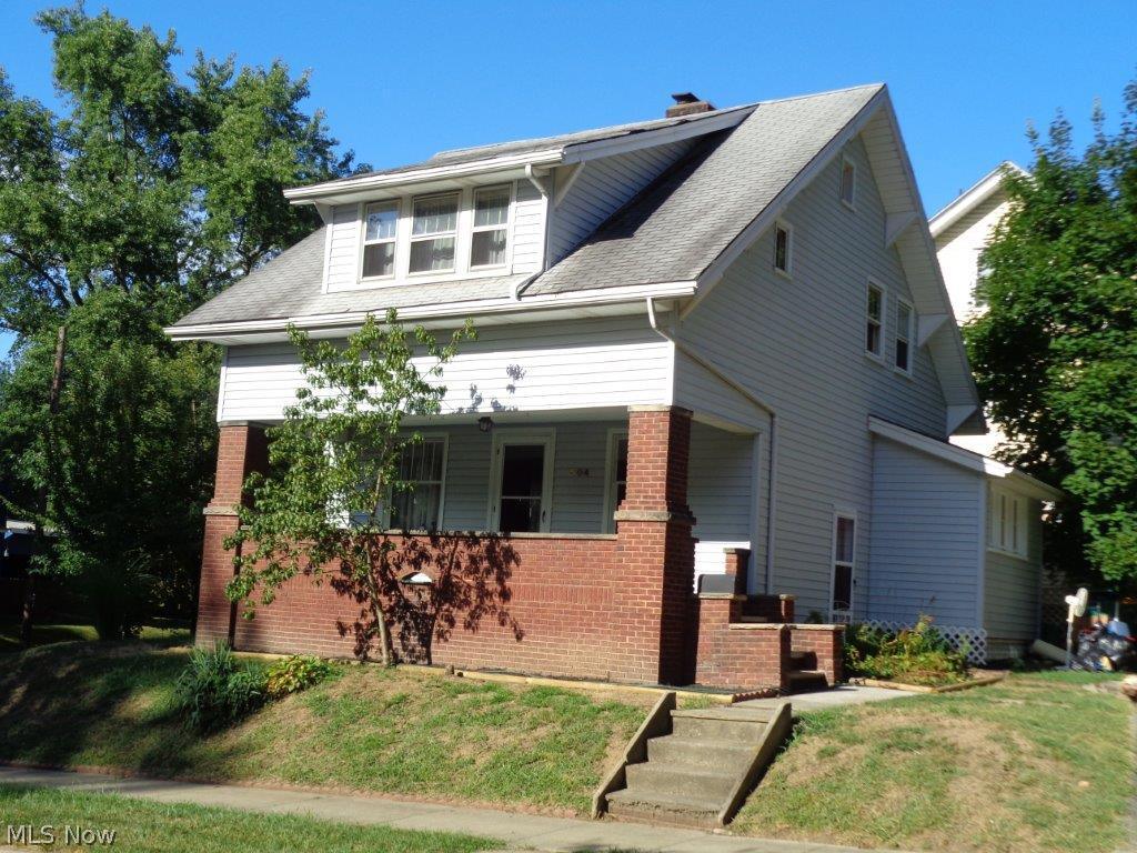 Remodeled in 1970 and nicely maintained this 3 bedroom, 2 full bath home is move-in ready today.   Beautiful woodwork, hardwood allergy-free flooring with ceramic tile in kitchen and bath.  Lots of kitchen cupboards and counter space, new double stainless steel sink in this bright and cheery kitchen that includes stove, refrigerator, dishwasher, and microwave.   Washer and dryer also remain.  Gracious floor plan and spacious rooms make for comfortable every-day family living.   Charming features with modern updates, very nice light fixtures, brick-gas-start fireplace, and a 5x6 walk-in closet you will appreciate.   Bring your favorite relaxation chair for the wonderful 7x23 covered front porch roomy enough to enjoy container gardening.   Lots of natural light, all rooms freshly painted, this is a very clean home including basement utility and exercise rooms.   The brick and vinyl exterior, insulation, and storm windows provide low utility bills making this home especially affordable. N