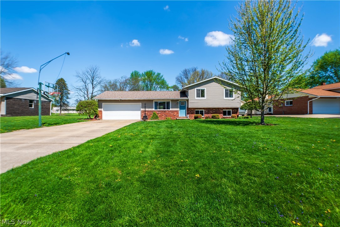 Welcome home to this modern split level style home located in Lake Township. As you make your way inside, you will be greeted by the natural flow and openness of this home. The living room featuring new white oak LVT flooring flows into the spacious kitchen that connects to the dining area that overlooks the entire back yard. Downstairs features an additional finished living room to entertain or to just wind down and relax. Upstairs has three bedrooms alongside a full bath as well as a half bath off the master bedroom. Outside, you have plenty of yard space and a two car garage. This home is move in ready and just needs you to make it yours. Call to schedule your private showing today !