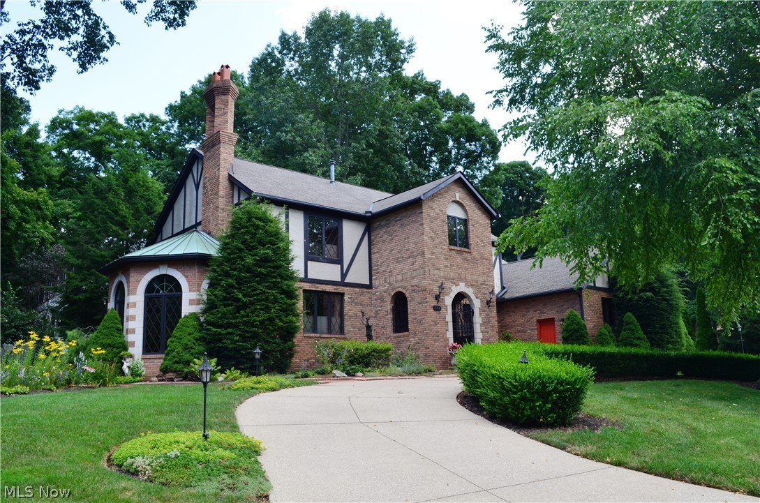 Sensational, English style custom tudor in desirable Fairlawn Hts. presents superb craftsmanship and design throughout. Idyllic setting includes distinctive wrought iron gates, barnstone wall, brick hand laid walkways & patios, gas fired pizza oven, and perennial gardens w/wall of bamboo trees.
Inviting formal living room with gas frpl and hdwd floors. Dining room features bay window and Tiffany chandelier. Turret style library w/fl to ceiling ladder, palladium windows, and French doors to outdoors. Gorgeous chef kitchen offers hickory floors, granite counters/1 heated, dbl ovens, copper sink, wine cooler, w/in pantry, leaded doors/cabinets, and more. Family rm w/frpl and built-ins.  Amazing atrium/sunrm features hot tub and 2 sets of sliders. FF laundry & spacious guest bath. Master bdrm ste. boasts balcony deck and priv.bath. Finished LL fam. rm, brick frpl, kitchen & wet bar.  3 c gar.sec sys. meticulously maintained.