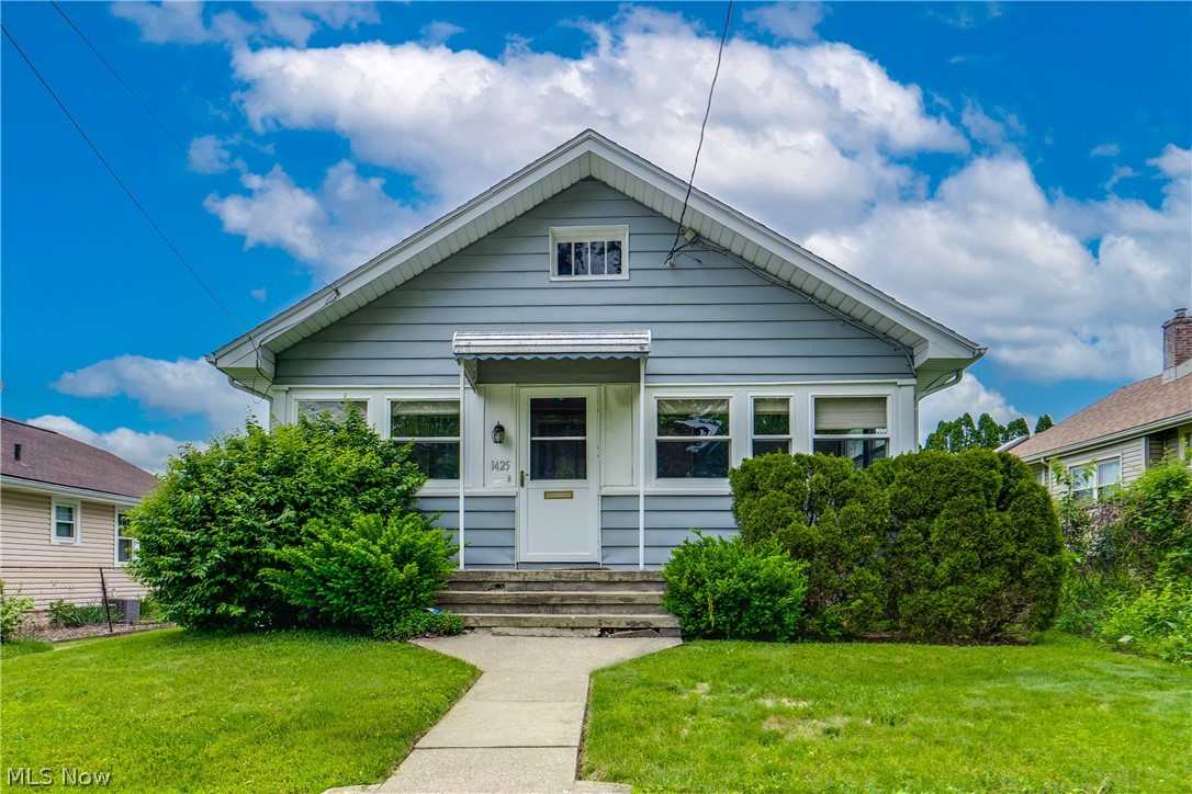 Charming Ranch in Goodyear Heights – Lovingly Maintained by Long-Time Owner. Don't miss this well-cared-for ranch nestled in the Goodyear Heights neighborhood, owned and meticulously maintained for many years. Rich with character, this home showcases beautiful original woodwork, gleaming hardwood floors, and tall baseboards. Step into the inviting enclosed front porch — the perfect spot to enjoy the neighborhood — and into a warm, welcoming living room. The comfortable living room flows into a formal dining room featuring charming built-in cabinetry framed by a large window. The kitchen offers cabinet space, and hardwood floors. Just off the kitchen, a sunny breakfast nook with oversized windows is the perfect place to start your morning.The main hallway continues the home's character with original woodwork and additional built-in storage. Two bedrooms, both with hardwood floors and overhead lighting, provide comfortable and cozy retreats. A full hall bath completes the first floor. Outside, enjoy a charming backyard with a stone patio. The property features a detached single-car garage plus a gravel drive. Don't miss your chance; schedule your showing today!