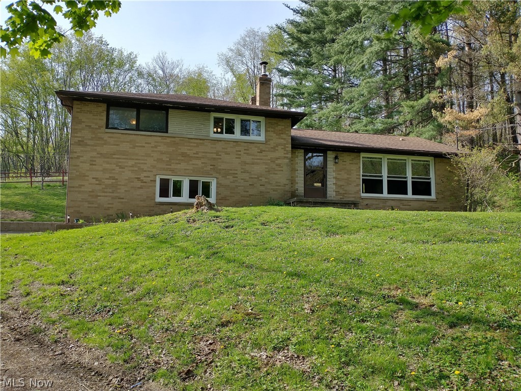 Looking for seclusion and privacy?  This is the home for you.  This home sits on over 11 acres, mostly wooded on the end of a half mile lane.  The home is an all brick split level home with 3 bedrooms and 2 full baths.  On the main level there is an office or possible 4th bedroom.  The downstairs has an outside access from the parking pad and features a good sized family room with a fireplace.  Also this level has a bonus room/workshop/craft room, this room also has hookups for washer and dryer and a full bathroom.  The lower level and basement has all glazed tile for the walls.  Upstairs has 3 bedrooms and a full bath.  This home is being sold "as is" with the seller making no repairs or updates.  The home does need some work to make it your own.  This home has a lot of potential.  Most of the windows have been replaced in 2017-19.  The outside has a detached 2 car garage with an upper level storage area and electric.  The parcel also includes 4 outbuildings/barns with electric that a