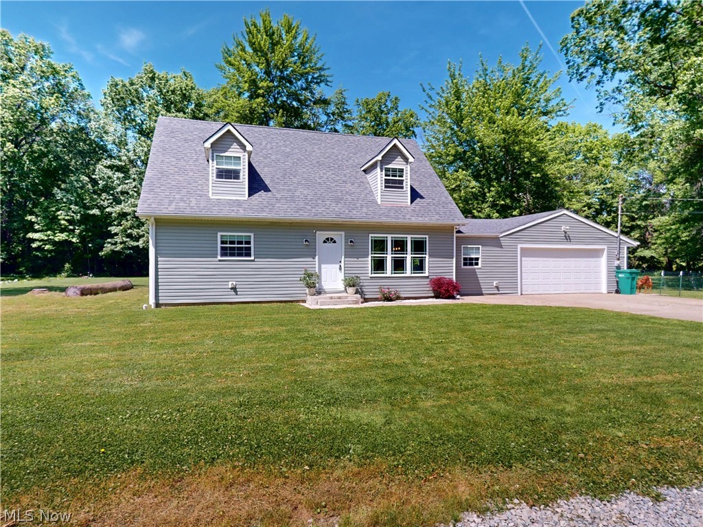 Completely remodeled in 2024, including new roof, new plumbing, new HVAC, new water heater, new flooring, updated electric,  appliances, and fixtures, this exceptional 4-bedroom, 2 full and 1 half bath home offers 2083 sq ft (original 1512 plus added 571 sq ft) of thoughtfully updated living space on 7.5 acres. Set well back from the road and surrounded by mature trees, the property provides a private setting with a long reinforced gravel driveway and partially paved access to the attached 2-car garage.  The first-floor owner's suite (currently used as an office) includes a walk-in closet, a luxurious bath with a soaking tub and walk-in shower. A convenient half bath for your guests is also located on the main level. The striking rustic-modern wraparound staircase leads to three spacious bedrooms and a large full bath upstairs.   Outside, the property is equipped for a variety of uses with a 24x40 two-story Garage/outbuilding featuring electric, gas service, workshop and a loft recreation area, plus a 24x60 four-bay garage offering abundant vehicle and storage space. Additional improvements include a full drainage system, custom window treatments, and a fenced dog run area.  Conveniently located near Geneva's wineries, state parks, golf courses, marinas, and the entertainment, dining, and waterfront attractions of Geneva-on-the-Lake, this move-in ready property offers a rare combination of modern updates, acreage, privacy, and versatile outbuildings.