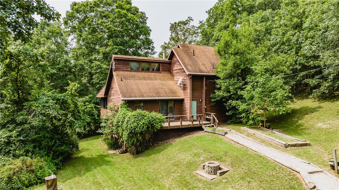 Your Country Getaway has now been found.  This wooded piece of WV Heaven offers privacy, wildlife, and a quaint modified  A-frame with 12 x 10 screened porch and generous decking.  *Shown as a BR on the Blueprints, Owner used it as an Office, as there is a wall of windows. Hard roads have been freshly blacktopped and a good gravel driveway leads you to the generous 24' x 24' separate two car garage, with concrete floor.  One door is 9' x 8' and the second is 8' x 7' plus man door. The former owner chose to continue using the well for his water source. There is a Clay Wood fire hydrant on the left side of entrance driveway entrance. A few adjacent neighbors have public water. Enjoy spectacular Fall and Winter views or watch "Spring come to Life!" But remember, "Summers are Cooler in the Country!" Immediate Occupancy available. 

Important side notes:  A new sump pump will be installed, discharging any water from the soon to be installed interior French Drain;  presently, the electrica
