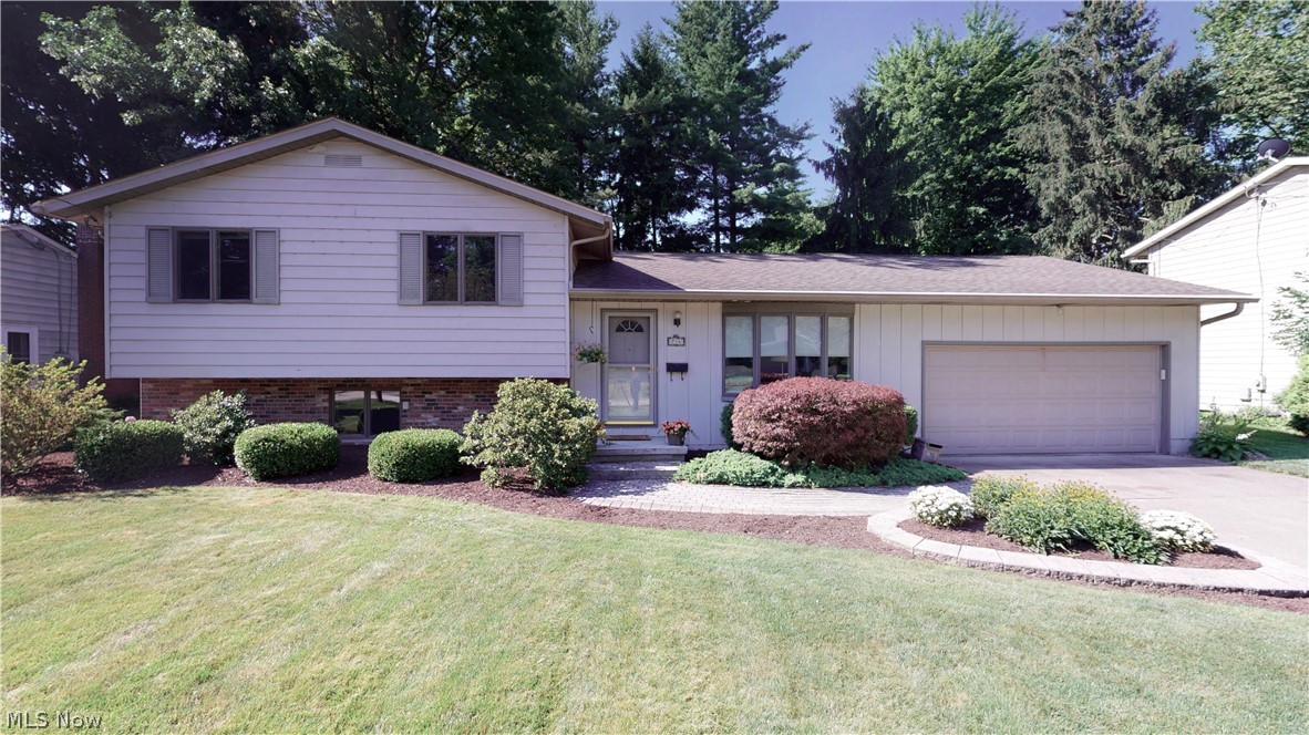 MUCH to love in this Kent, Ohio split! It starts with Curb Appeal and Setting... on the edge of Kent's Highland Park which becomes an extension of your yard without the maintenance! WOW... only a few homes in Kent can offer you that! Location demands your attention--walking distance to Kent State University, accessible to south-side shopping, restaurants, close to Routes 261,43 & 76!  This turn-key property offers large shaded deck, doggie door into outside fenced area w/ dog house, original restored hardwood in living room & wide entry hall (as well as hardwood under all bed carpets if one is interested in exposing). The built-ins, closets, and overall storage--incredible! Enjoy the open concept granite kitchen with nicely-kept cabinets into great room w/ gas fireplace and vaulted ceiling and--the most incredible part--amazing windows to the back yard~! Newer paint throughout, new on-trend carpeting in all bedrooms. Above-grade lower level family room w/ new laminate flooring/paint of