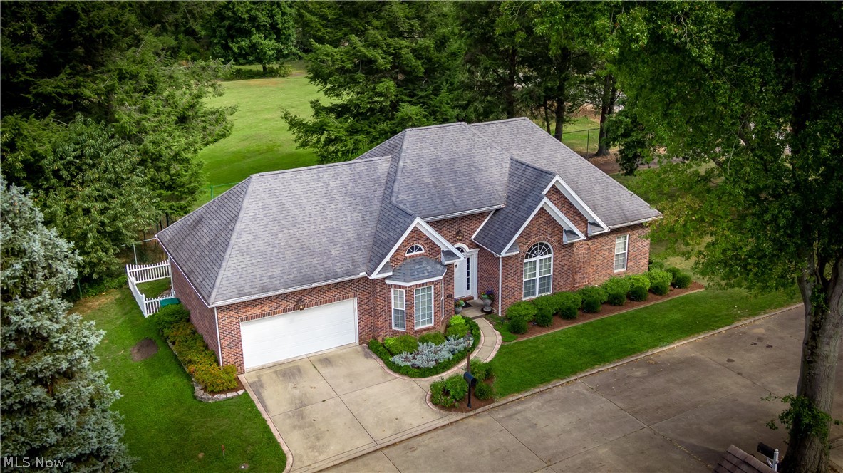 Classically styled with a clean modern feel this all brick floor plan offers total one floor living. The rooms are spacious with volume ceilings that are enhanced by hardwood flooring and oversized windows that bring view of golf course greens. Fireside Great room with center lined designed new kitchen complimented by white subway tile backsplash and granite counters that adjoins bayed dining room that opens to patio. The owners suite has trayed ceiling, two custom closets and updated bath with palladian window. Two additional guest rooms and second full bath. First floor laundry room. Recent appointments included handcrafted Bevolo lighting, black stainless appliances, tasteful interior painting, central vac and landscaping. The lower level has endless possibilities for additional living. Located within walking distance to the Country Club, schools and shopping. This like new home will not disappoint. .