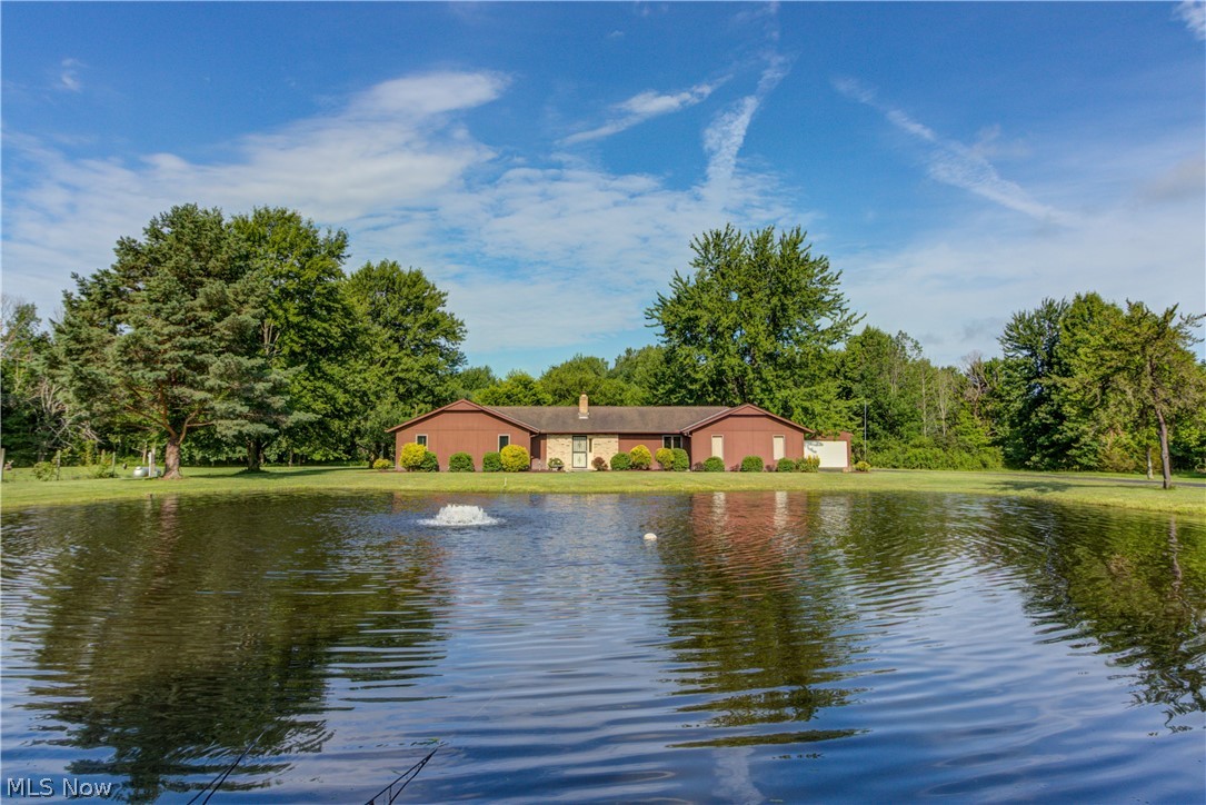 3 Bdr/2 Bath Ranch with a 1 Bdrm/1 Bath Handicap accessible in-law suite (built in '99) in Columbia Station!  This nice home sits 700 feet off the road with an asphalt drive, on over 8 acres, with a pond and 32x40 concrete floor Barn/Outbuilding.  The suite has a separate entrance and is also accessed through double doors off the main kitchen/dining area.  Very functional space could be ideal for several different uses.  Anderson windows less than ten years old.  Kitchen remodeled with newer cabinetry, including rollouts, huge pantry and peninsula eating area.  All stainless steel appliances including washer/dryer stay! Vinyl plank flooring installed in kitchen, entry and dining room and newer carpet with 5/8 pad (2015).  Spacious Family room has fireplace insert.  Newer interior doors and baseboard/trim in 2014. Master bedroom has walk-in closet and master bath.  Nice closet space in bedrooms.  1/4 stocked pond, approx 12 ft deep is fully stocked out front.  Outbuilding has concrete f