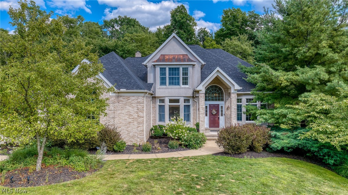 A stunning colonial home tucked away at the end of a private cul-de-sac in the prestigious Signature of Solon II, offering timeless elegance, privacy, and exceptional living spaces. The impressive brick exterior and inviting front porch welcomes you into a grand foyer featuring soaring ceilings, beautiful tile flooring, and abundant natural light.

The main level showcases a formal living room with crown molding, an elegant dining room with wainscoting, and a beautifully appointed home office with custom built-ins and wood paneling. The heart of the home features an open-concept kitchen and family room with stainless steel appliances, granite countertops, a large island, fireplace, and scenic views of the private backyard. Two bonus murphy rooms add to the custom appeal to this home.

Upstairs, the spacious owner’s suite offers a walk-in closet and spa-like bath with soaking tub, separate shower, and dual vanities with heated floors. Three additional bedrooms provide flexibility and comfort. The finished walk-out basement expands the living space with endless possibilities for entertaining, recreation, or additional living areas.

Enjoy the beautifully landscaped backyard with a working sprinkler system and a heated garage. Recent updates include a furnace (less than 1 year old), AC (less than 1 year old), water heater (2 years old), roof (1–2 years old), garage doors (less than 1 year old, special 9ft door), and updated electrical panel.

A rare opportunity to own a meticulously maintained home in one of Solon’s most desirable communities.