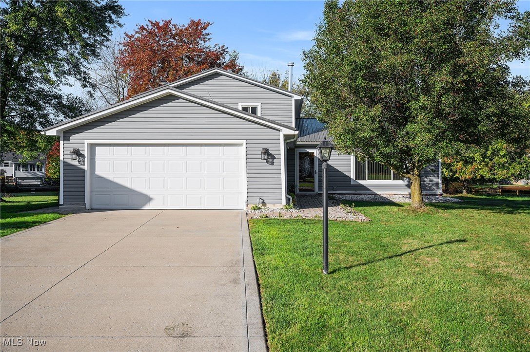 THIS could be THE PLACE!  THIS HOME IS A MUST SEE... 4 bed, 2 full bath home is situated in the much desired location of Aurora Shores, with a private dock and water access to Aurora Lake! Every inch of this home has been updated, and it just waits for you to move in! As you pull up to the home note the new driveway, front walk, vinyl siding and metal roof!! No overgrown landscaping here! All of that has been removed to provide you with a blank canvas!  As you enter this immaculately kept home notice the gleaming hardwood floors that run through the dining and living rooms. And it doesn't end there!  The completely updated kitchen has premiere stainless appliances including a 5 burner cooktop,  wall oven and microwave, high end dishwasher, French door refrigerator, as well as quartz counters, solid wood, 42" custom cabinetry, tiled backsplash, pantry and more!! As you head to the lower level, you will find a beautifully tiled  family room with fireplace, a bedroom, full bath and laundry area! Enjoy the view of this amazing property with the lower level walkout, glass enclosed patio, and an outdoor paver patio area! Enjoy every bit of your canal water view, amazing yard, and personal boat dock. The upper level does not disappoint either! With hardwood floors, large closets, master bedroom, 2 additional, nice sized bedrooms, and a fully remodeled bath. Additionally, there is a tankless water heater, newer windows, newer doors, newer garage door and an updated electrical panel. The only thing missing is you! The HOA includes 2 pools, Community Center, marina, tennis courts, playground, and volleyball courts!