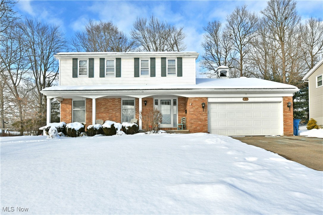 Welcome home to the impressively spacious and beautifully styled offerings of this standout Girard estate. Tucked away in a quiet yet highly desirable neighborhood, this two-story home sits proudly on an elevated lot, showcasing a covered front porch, attached two-car garage, and warm brick accents that add timeless curb appeal. Out back, a covered patio is ready and waiting for spring evenings, summer cookouts, and relaxed mornings with coffee in hand, all overlooking a backyard with plenty of space to play, garden, or simply unwind. Step inside to a sunlit foyer featuring a carpeted staircase and a convenient half bath before opening into a generously sized living room with rich hardwood-style flooring and an inviting, airy feel. Around the corner, a formal dining room continues the classic charm with a wrapping chair rail, perfect for both holiday gatherings and everyday dinners. The well-appointed kitchen is designed for both function and comfort, offering hidden pantry storage, abundant countertop space, and tile flooring that flows into a casual dining nook ideal for busy mornings, homework time, or cozy meals. A sunken family room completes the main level, highlighted by a charming fireplace and direct access to the rear patio, creating a warm and welcoming space to relax or entertain guests. Upstairs, four comfortable bedrooms provide room for everyone, joined by a stylish full bath with an elegantly tiled shower. The spacious master suite serves as a private retreat with its own full bath and multiple closets, giving you the space and storage you’ve been looking for. The lower level adds even more flexibility with a partially finished rec room, laundry area, and additional space for a home gym, workshop, or extra storage. This home also comes with a one-year home warranty!