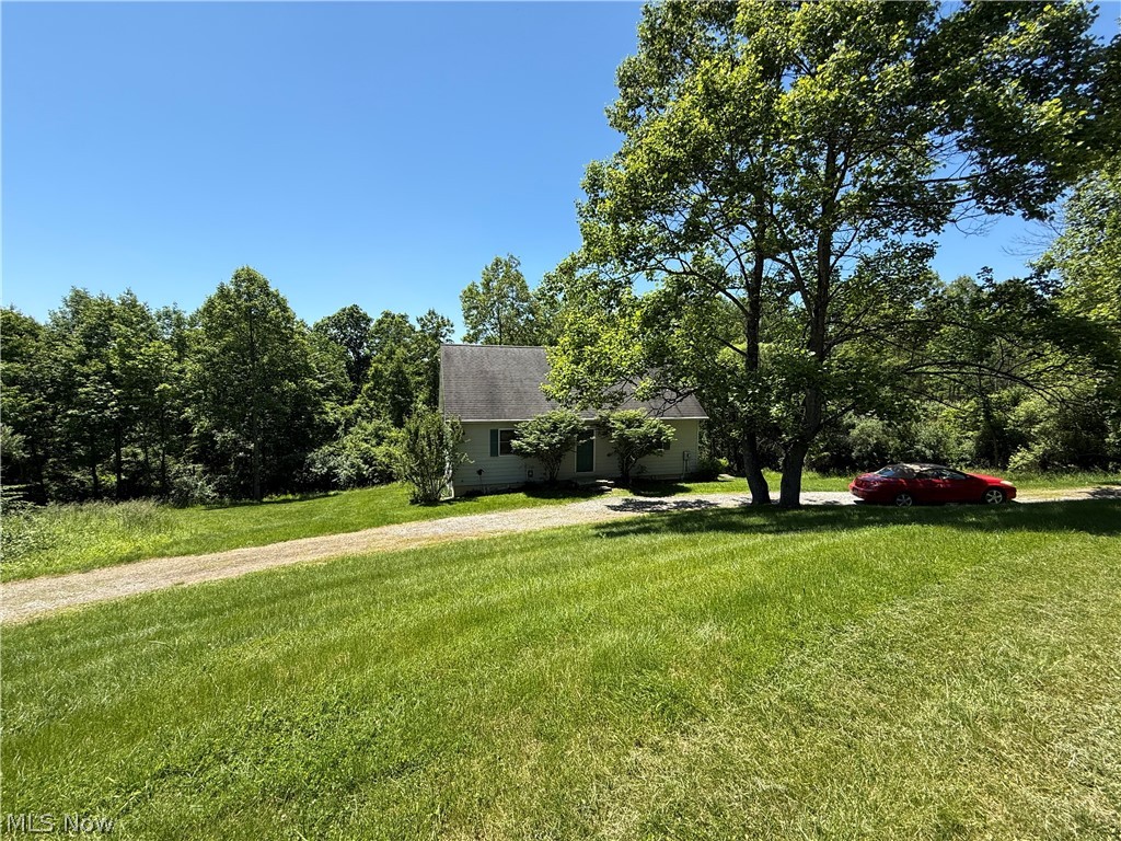 Being Sold TURNKEY! When you walk through the front door your eyes will immediately be drawn to the Soaring WALL OF WINDOWS in the Great Room and the natural views.  The open floor plan greets you with the open living area encompassing the Great Room, Kitchen and Spacious Eating Area all under a soaring Vaulted Ceiling with a Large Beam that puts an exclamation mark the room and a smile on your face when you return home.  This feels like HOME, not just a house. The kitchen is a SCHROCK Kitchen with an Attractive ISLAND with Raised Panel Side Cabinets.   The Great Room features a corner gas fireplace; to be converted to gas from propane. This is a Very Nice Home that feels much newer than its 26 year age.  It is a Wonderful location quietly tucked away in an area of nice homes of this Lake Buckhorn Community. No other homes are visible to the rear of the house.  The only view you have from your low maintenance composite & vinyl deck will be trees & treetops from this low maintenance vinyl-sided home.  There are 2 Bedrooms and a Full Bath to the rear of the home.  Topping off the 1st floor is peaceful composite & vinyl rear deck for coffee, meals, refreshment and relaxation.  Upstairs is a Very Large Loft Bedroom with Wonderful Views through the Soaring Wall of Windows at the end of the Great Room. The Loft is adorned with the same Beam that extends through the ceiling of the Living Area below. The WALKOUT Basement has another FULL BATH & a room that obviously was thought of as future expansion for a bedroom when the home was built. The main open area that you step into when you come down the stairs would be a lovely Family Room w large DayLight windows & French Doors to the area under the deck above. This home has been a Wonderful Get-A-Way for the present owners to enjoy. It seem perfect for a get-a-way home. Finishing the basement and it certainly could be a fulltime home. This is an opportunity to join Lake Buckhorn & enjoy all this spectacular community offers.