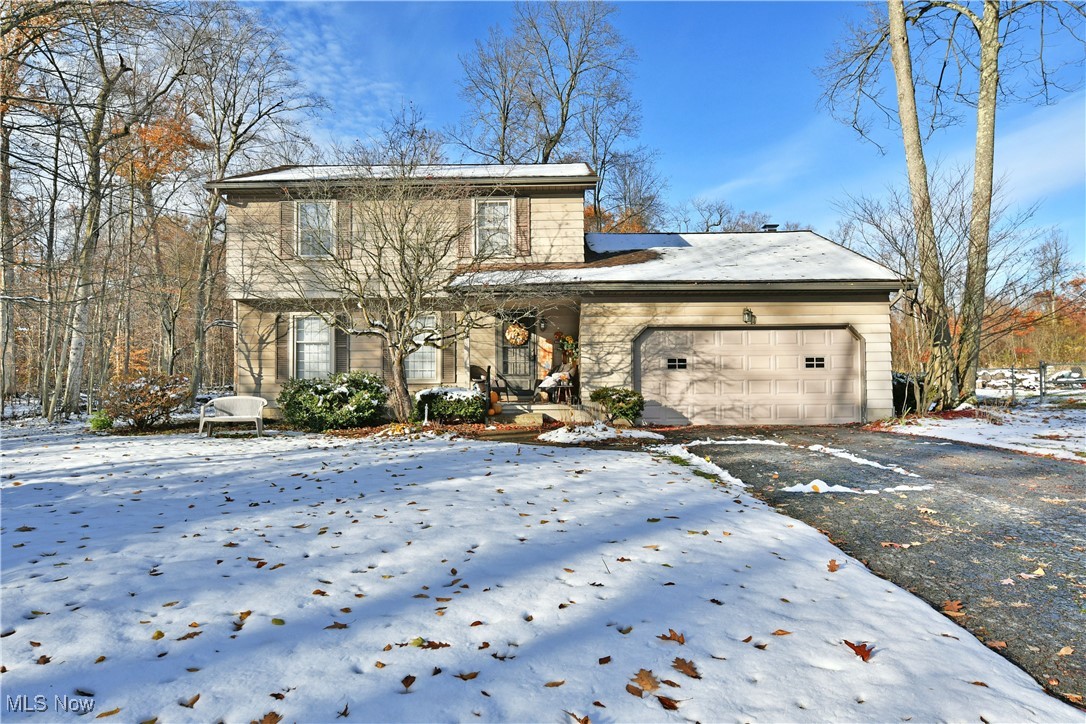 Private, scenic and filled with comfortable charm, this endearing Liberty home has everything you’ve been looking for! Tucked away in a quiet corner along a dead-end extension, this residence takes full advantage of the wrapping, nearby tree line to create a unique and serene setting. Take in the views from the prominent rear deck as you watch the leaves change and the snow fall. Warm, natural colors comprise the exterior for an earthy and engaging feel. Step inside as the welcoming foyer reveals a carpeted staircase and short hall that passes by the spacious living room. Here, hardwood styled flooring continues around the corner and into a graciously appointed formal dining room where you can enjoy a tasty, home-cooked meal. A large serving window gets it to the table faster as you peer into the adjacent kitchen, delighting with its ample footprint that includes eat-in-dining space. Cherry colored cabinetry adds to the allure. Around the corner, a lovely half bath awaits the entrance to a daring rear family room, wrapped in stained wood paneling and showcasing a towering brick mantle with its inset fireplace. Sliding glass doors allow for instant rear deck access. Upstairs, a sizeable full bath graces the landing while the main hall transcends a trio of bright and colorful bedrooms; each with hardwood flooring. Laundry service and storage is located at the basement level.
