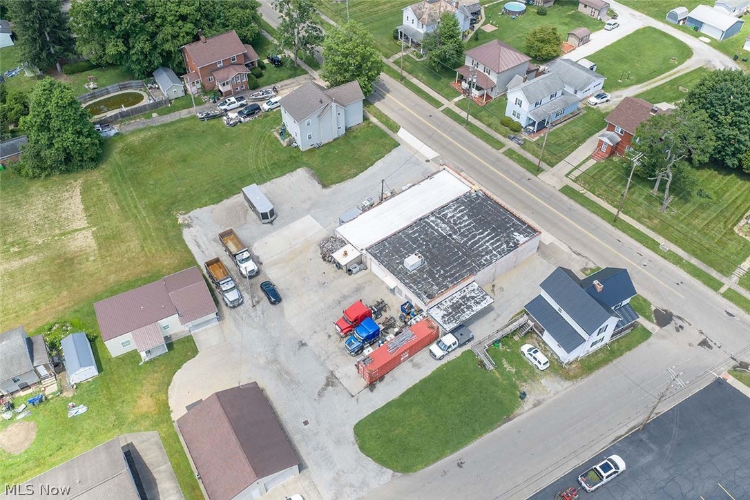 Multi-structure commercial property offering strong utility and redevelopment potential. Anchored by a 5,396 sq ft service garage with updated improvements, the site also includes a 300 sq ft office, a 100 sq ft shed, and two canopy structures. Nearly 5,000 sq ft of concrete paving supports heavy equipment, fleet operations, or contractor use. With a mix of newer and legacy structures, this property provides immediate functionality with long-term upside for expansion or modernization. Schedule a private showing today!