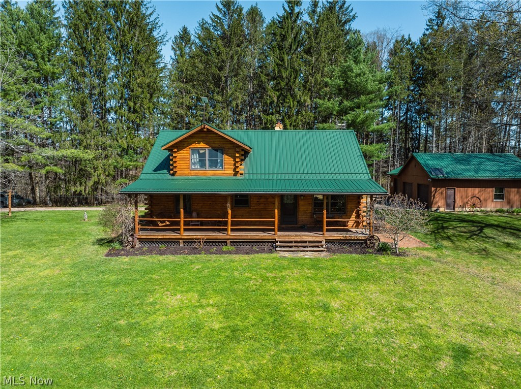 Beautiful 3-bedroom, 2-bath log cabin set on 71 private acres, all within walking distance of Tappan Lake. The main level is beautifully finished and full of rustic charm, featuring a stunning floor-to-ceiling stone fireplace, cozy wood-burning heat, and hand-chiseled exposed log beams. The recently updated kitchen includes newer appliances and flows seamlessly into the open dining and living areas. This level also offers two bedrooms and a nicely updated full bathroom. A spacious loft overlooks the main floor and serves as a large third bedroom, adding to the cabin’s warm, open feel. The finished basement provides additional living space with a full bathroom, a large entertainment or family room, multiple storage closets, and a utility area. Step outside and you’ll quickly see what sets this property apart. The setting is truly second to none, offering complete privacy and endless possibilities—whether you want to build additional structures, tend a garden, or keep animals. The property already features a 26’ x 56’ shop/garage and an established garden area. The land lays beautifully, with gently rolling terrain, valleys, natural pinch points, and a long ridge top tying it all together. For the hunters out there, the hunting potential here is excellent, with abundant wildlife sign, surrounding wooded acreage, and multiple ideal locations for food plots and stand setups. The timber is also a valuable asset, with a strong stand of quality trees approaching harvest age. If you’re looking for a property that truly has it all, this is it. Schedule your showing today before this one-of-a-kind opportunity is gone.