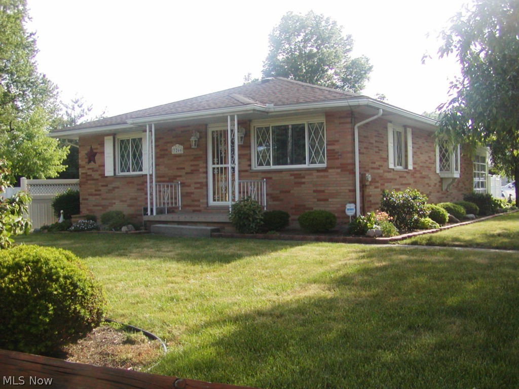Beautiful, well maintained brick ranch on 65' by 165' manicured lawn. This home really shows pride of ownership from the immaculate condition to the wonderful wood floors in most rooms. Large bright living room, newer applianced kitchen and dining area with bay window. Basement recreation room plus extra room for office, media room or computer room. Glass block windows in the basement. Home also has replacement windows. Relax in your cheerful sunroom or enjoy Summer days on your patio surrounded by a bright white  privacy fence great for entertaining. America's Preferred Home Warranty also included.