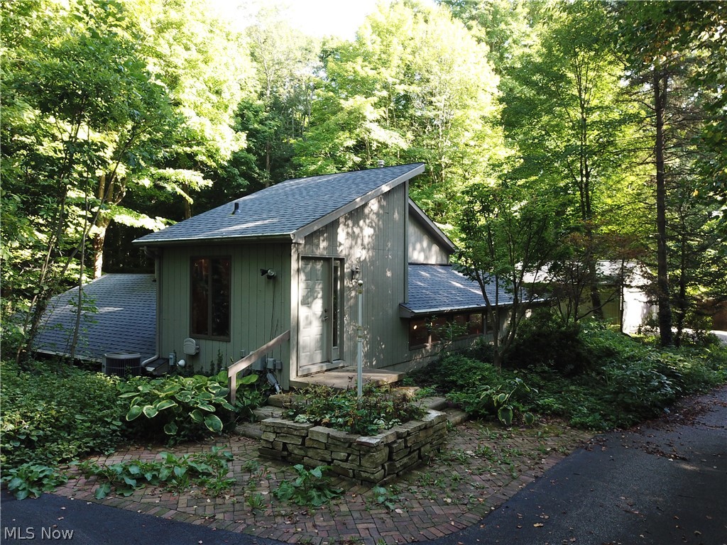 Wow! If privacy is what you want, you'll find it here!  This most unusual, one owner home was built into the land in order to take advantage of the creek/hillside views.  The long driveway includes a circle turn around, as well as access to the front foyer entrance, the deck leading to the main level of the home, as well as access to the 2.5 car garage and the storage barn.  On the main floor you will find: a great room with vaulted ceilings, gas fireplace and large windows to enjoy the view, an eat-in kitchen with maple cabinetry, vaulted ceilings and transom windows across the top of the cabinets for natural light, one side of the home features bedroom #2 and the hall bathroom, on the other side,  the master bedroom features an ensuite bathroom and a private sunroom with access to the deck.  Upstairs is a large open loft area which was built as bedroom #3, but, was used as a studio.  The deck leads to a large screened Gazebo over the creek bed.    Updates:  House roof 2018, Garage ro