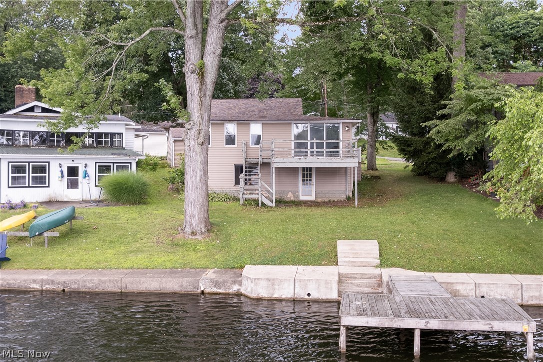 Check out this amazing lakefront opportunity on Hower Lake in beautiful Portage Lakes! Peaceful setting and so much potential. Lakefront fixer-upper featuring 2 bedrooms, living room with fireplace, 1.5 baths, unfinished walk-out basement, private dock, 1 car garage, and serene views. Hower Lake is close to all the action Portage Lakes has to offer, yet quiet and private. Bring your ideas and unlock some potential --this one is packed with opportunity whether you are a seasoned investor or looking for lakefront living at a fraction of the price!