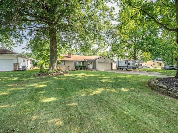Welcome home to this beautifully maintained 3-bedroom, 1.5-bath Austintown ranch that’s been thoughtfully updated inside and out! Offering comfortable one-floor living, this home combines classic charm with modern improvements for true move-in-ready convenience. Step inside to find original hardwood floors in great condition, complemented by new ceiling fans and light fixtures throughout. The back family/living room features brand new flooring 2026, creating a warm and inviting space to relax or entertain. The refinished bathroom includes the luxury of heated floors, beautiful tiled stub/shower combo while the half bath features a new commode installed in 2026. The kitchen has been updated with a new refrigerator 2026, and the home’s mechanicals have been exceptionally well maintained. The A/C was replaced in 2021, hot water tank installed in 2022, and the furnace internal components were completely replaced in 2022, providing peace of mind for years to come. Outside, you’ll appreciate the 2 car attached garage, freshly painted and with new lighting 2025, along with three garage door openers. The additional part of the driveway was professionally rebuilt with a new stone base and compacted gravel in 2026 for lasting durability. The fireplace has been cleaned and inspected, the main drain was scoped and serviced in 2026, a new water shut-off was installed at the meter, and a new electrical line was run for an electric dryer. Technology and convenience are already in place with Armstrong Fiber installed, a paid for ADT security system (buyer only needs to activate service) and a keyless front entry with programmable code lock. The seller will also leave the bedroom TV, garage TV, and TV wall mounts. Enjoy a nice backyard with plenty of room for outdoor entertaining, gardening, or simply relaxing. This is a home where the major updates have already been done, just move in and enjoy