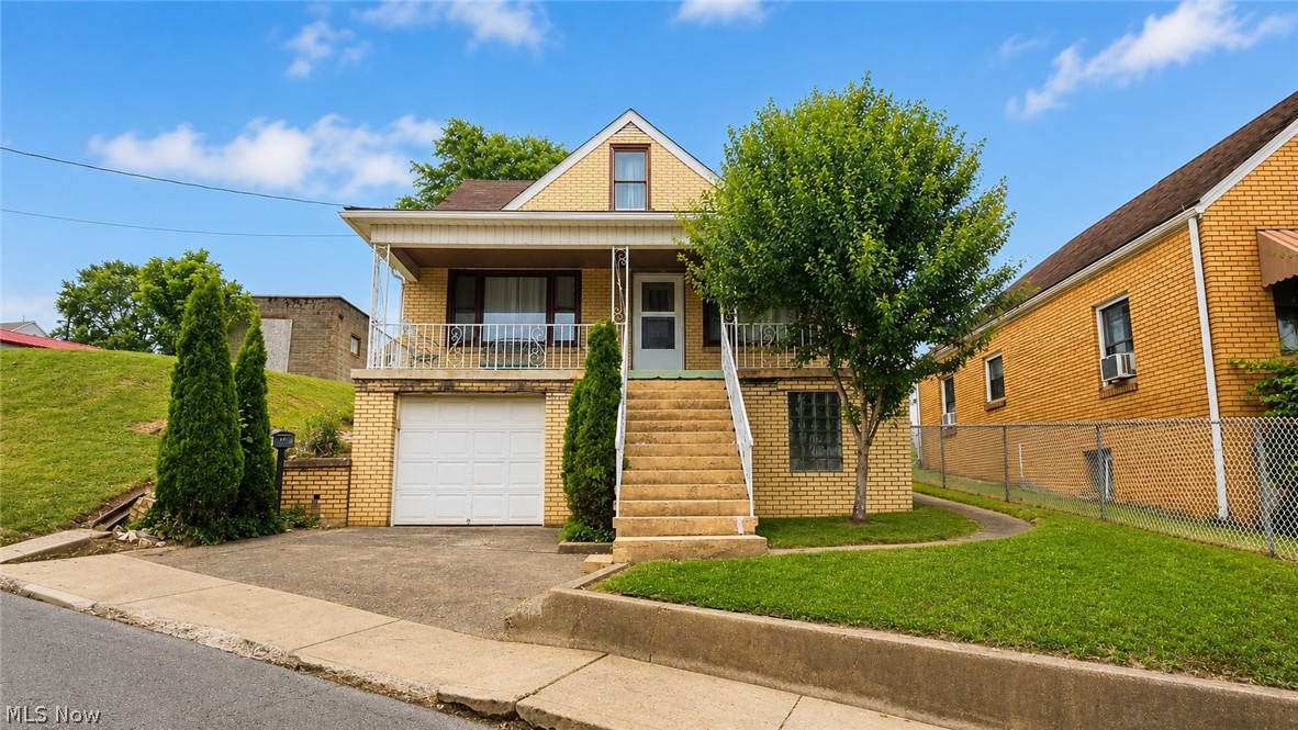 Welcome home to this classic brick Cape Cod offering timeless character, solid construction, and plenty of space both inside and out. This home features a large covered front porch perfect for relaxing and enjoying the neighborhood views. Inside, you'll find beautiful hardwood floors throughout the main living area, adding warmth and charm to the spacious living room. The eat-in kitchen offers an abundance of solid wood cabinetry, ample countertop space, and included appliances. The upper level provides a large room that can serve as a bedroom, family room, home office, or flexible living space. The lower level includes a utility area, additional storage space, and bathroom / shower area, providing functionality and room for future possibilities. Contact your agent today to schedule your private showing!