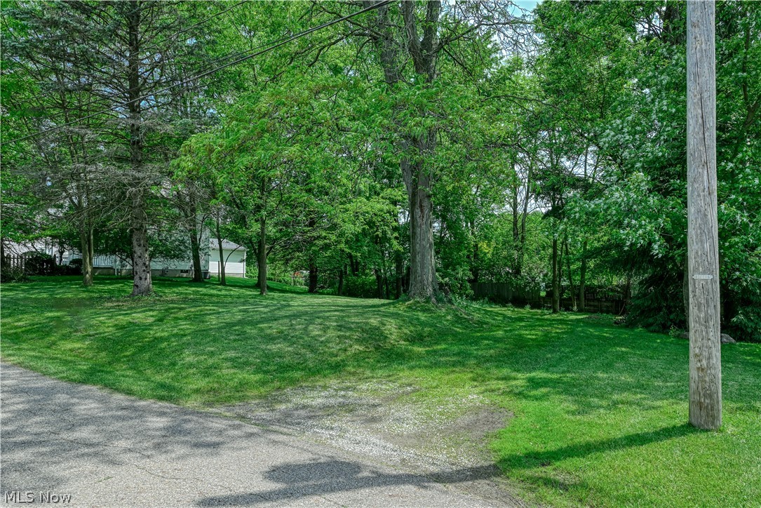 Your vision is waiting to come to life on this double lot nestled on a quiet, dead-end street. Offering a beautiful, park-like setting with some mature trees, this property serves as the perfect canvas to build the home of your dreams. For buyers looking for privacy without sacrificing convenience, you will love the tucked away feel that remains just minutes from all the vibrant shopping, dining, and community events Cuyahoga Falls has to offer. All public utilities are readily available at the street, and the driveway placement has already been established, saving you valuable time and prep work. Whether you are a homeowner looking to design a custom sanctuary, or a builder/investor searching for your next profitable project, this rare find delivers unmatched potential. Bring your builder and explore the possibilities today!
