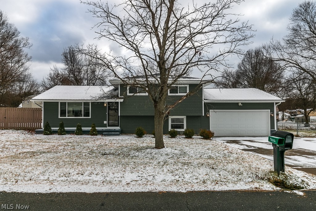 Updated and on-trend!  Move right into this charming, open concept, bi-level home in Kent.  This 3 bedroom, 2 bath home with over-sized, attached garage has been completely renovated to perfection!  The custom kitchen features high-grade granite, flooring, and stainless steel appliances, everything that today’s home buyers are looking for.  Finished space in the lower-level is wired for a projection entertainment system and butler pantry:  perfect for stay-at-home movie nights or a party extraordinaire!  Finished lower level not counted in total square footage. Double sized lot with partial fencing gives you plenty of space to spread out.  Mechanicals and systems were all recently replaced ~ siding, windows, roof, gutters, windows, furnace, A/C, garage door, electrical panel, brought up to 200 AMP service.  Come see this completely re-imagined home, you will fall in love!