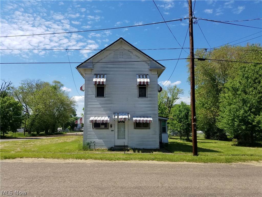 Two-story, 3-bedroom house located on three lots on 1st Street which runs along the Ohio River!  If you like to go boating and/or fishing, you are located steps away from Captina Creek and the Ohio River.  House was previously used as a rental and is being sold As Is.  House is located across the street from the old Hotel/Restaurant which is also for sale.  Total acreage of the three lots is 0.38.  All mineral rights to be retained by seller.