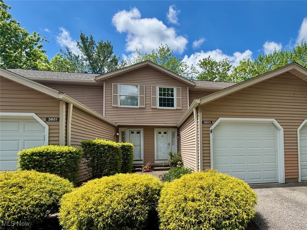 Don’t miss this opportunity! This 2-bedroom, 1.5-bathroom townhome offers a practical layout with plenty of space and potential.  The first floor features a spacious living room with a cozy stone fireplace, a kitchen equipped with all appliances, and a convenient half bath. Step through the sliding glass door to your private patio, enclosed by a tall vinyl privacy fence—perfect for relaxing or entertaining. The finished lower level includes a large rec room, laundry area, and potential to re-install a half bath. Upstairs you'll find two generously sized bedrooms and a full bathroom. Enjoy the convenience of a 1-car attached garage plus plenty of additional common area parking. Updates include: Furnace, A/C, hot water tank, windows, slider door, roof, garage door opener, vinyl fencing patio enclosure, bedroom fans, and a COVE security system. A home warranty is included for added peace of mind. Schedule your showing today!
