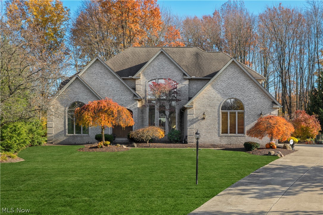 This stunning colonial home was custom built in 1993 and is located on a quiet cul-de-sac. Features such as the cathedral ceilings, arched doorways, large domed windows, and neutral interior set this home aside from the rest. The first floor boasts a main living room, family room, kitchen, dining room, and master suite which are all filled with an immense amount of natural light. The spacious eat-in kitchen includes stainless steel appliances, granite countertops, maple blonde cabinetry, and ample storage. Access to the backyard oasis through the sliding doors create seamless entertainment. The first floor master suite is large and features soaking tub, his & hers vanities, and walk-in shower. The spiral staircases lead you to the second floor where you will find 2 full baths, 3 beds, and a cozy loft perfect for potential office space. The fully finished lower level is every entertainment lover's dream and features a theater room, built in bar, fireplace, full kitchen with fridge, stove, dishwasher, and microwave, and full bathroom with shower. The wooded private backyard retreat can be enjoyed all year round and includes a fully fenced in in-ground pool.