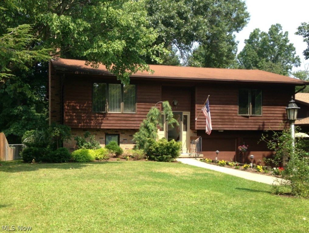 Nicely maintained bi-level home!  Awesome tiered professional landscaping in back and wooded beyond.  Both a screen room and a deck for your outdoor enjoyment!  Nice open living room/dining room area with fireplace.  Two bedrooms on the main floor.  Lower level could be large 3rd bedroom (with a full closet AND a full bathroom on lower level) or use as a family room!  Lots of options for your particular needs.  First floor laundry. Two-car attached garage, plus a storage shed in back.  All this PLUS a Home Warranty offered by the seller!  Don't miss out!