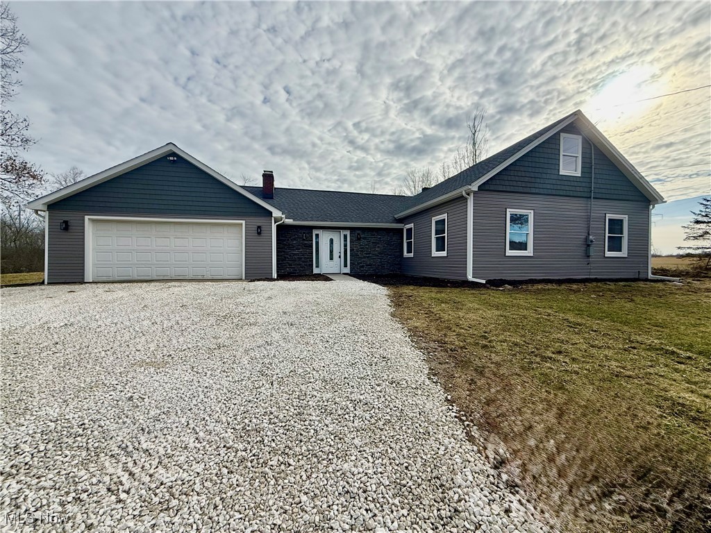Welcome to 4670 Sandy Lake Rd, Rootstown Township—a beautifully newly renovated 3-bedroom, 2-full bathroom home nestled on 1.10 acres with serene, private views that make it feel even more expansive. With plenty of frontage tucked away from the road, this 1,899 sq. ft. gem offers an open floor plan, modern upgrades, fixtures and inviting curb appeal with stone accents, new siding, rooof, gutters, and downspouts. Step inside to find LVP flooring throughout and a newly installed wood-burning stone fireplace in the main living area, perfect for cozy evenings. The stunning kitchen boasts white soft-close cabinetry, granite countertops, backsplash, pantry, and an oversized island, complemented by brand-new stainless steel appliances. The upstairs loft provides flexibility as an additional bedroom, playroom, game room, or office. The primary bedroom has 2 closets and the fully renovated bathrooms exude modern elegance, while the laundry room comes equipped with a washer and dryer for added convenience. A 2-car attached garage (22x26) ensures ample storage space. Enjoy peaceful outdoor living with a private backyard patio overlooking wooded views. Major updates include: New Aeration Septic System with a transferable warranty (2025) | City water tie-in (2024) | Windows (2024) HVAC (2024) Roof/Gutters/Downspouts (2024) | Electrical/Plumbing (2024) | Propane tank filled (March 2025). Rootstown LSD. With immediate occupancy available, this is your chance to own an exceptional move-in-ready home! Country-like setting yet still accessible to all amenities + St Rt 76, State Rt 5 & St Rt 44. Don’t miss out—schedule your showing today!