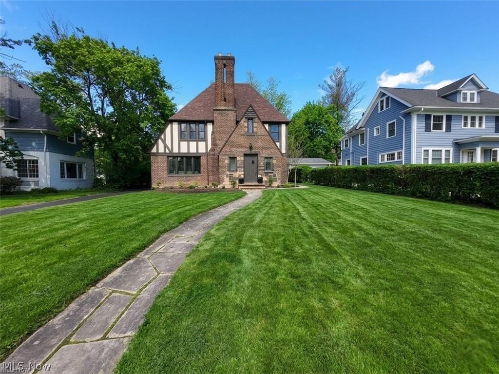 Timeless in the truest sense, this Shaker Heights Revival Tudor possesses the kind of presence that cannot be manufactured. Point of sale compliant and offered with a home warranty, this exceptional residence has been meticulously prepared from top to bottom. A full inspection report is available, with repairs thoughtfully completed to provide peace of mind and a truly move-in-ready experience. Its stately brick facade, steep gables, and half-timbering speak to an architectural tradition both storied and enduring, delivering unforgettable curb appeal before you ever reach the front door. Inside, refinished hardwood floors and sun-drenched interiors reveal a home where restored original character and thoughtful modern updates exist in seamless conversation. Major improvements include updated plumbing and electrical, a complete tear-off roof, new gutters, replacement windows, and additional repairs identified through inspection. The great room, anchored by a fireplace and framed by original French doors, flows effortlessly to the dining room and a light-filled sunroom that becomes the heart of daily life. The modern kitchen features white shaker cabinetry, quartz countertops, stainless steel appliances, and tile flooring, while a conveniently placed powder room completes the first floor. Upstairs, the spacious primary suite is paired with an updated Jack and Jill bath, while three additional bedrooms are served by a fully renovated full bath. The third floor offers a private retreat with a bedroom and full bath featuring a stunning clawfoot tub, ideal as a primary oasis, guest suite, or teen suite. The basement provides abundant storage and functionality. Walking distance to Shaker Heights schools and the Van Aken District, this home offers timeless architecture, modern peace of mind, and the rare opportunity to own a residence where every detail has been thoughtfully preserved and improved. This is the kind of home you stop looking after you find.