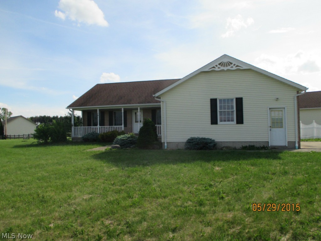 Great country location with large outbuilding with concrete floor and half bath.  Home features 3 bedrooms and 2 baths, with nice sun room off rear.