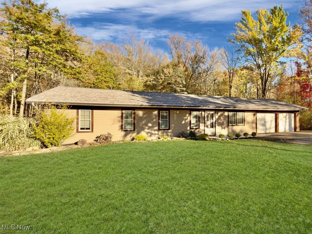 Is there a 3-bedroom ranch in Mentor on acreage that's Turn Key & Fully Remodeled? Yes! and it's stunning! Welcome to 8285 Munson Road, a fully remodeled 3-bed, ranch nestled on a Rare 1.94-acre park-like lot in Mentor School District. Just 3/4 mile from Mentor High School, this move-in-ready home blends comfort, privacy, and location.

Inside, you'll love the airy open-concept layout with all-new LVP flooring, recessed LED lighting, and a stone fireplace focal point. The custom kitchen pops with sleek green cabinetry, quartz counters, and new stainless steel appliances. A dual-sink remodeled bathroom adds everyday function and style.

The flexible 3-season room opens to a massive concrete patio and serene parklike backyard framed by mature trees. Enjoy entertaining, relaxing, or watching the seasons change in total privacy. A 2-car attached garage, turnaround driveway, new windows, new roof, new A/C, and fresh paint & fixtures throughout make this a rare turnkey opportunity on an unbelievable setting.

Hard to find this much land with this many updates, this close to everything Mentor has to offer. Shopping, schools, dining, parks, and freeway access are all minutes away.