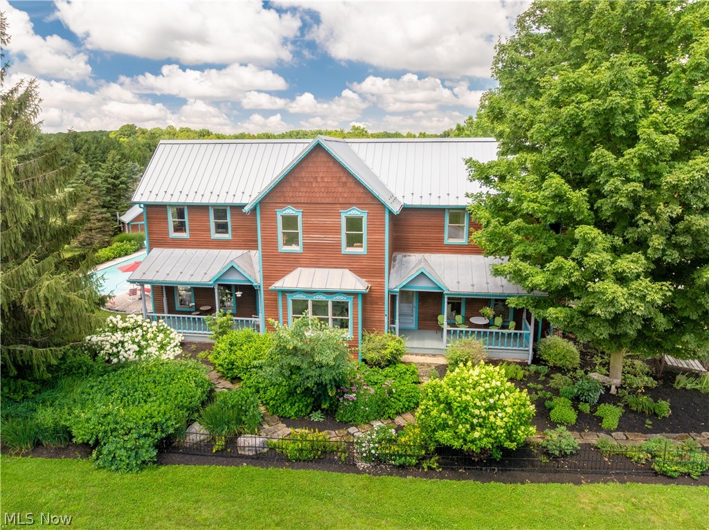 Extraordinary 18-acre luxury estate and equestrian property in the highly desirable Highland Local School District. This exceptional 7-bedroom, 9,000+ sq. ft. custom residence blends timeless craftsmanship with country living. A metal roof, expansive covered porches, hickory floors, and impressive timber-frame construction create warmth and character throughout.
The heart of the home is a breathtaking gourmet kitchen and gathering area featuring soaring wood beams, custom cherry and hickory cabinetry, a center island with breakfast bar, abundant workspace, and an impressive 12x11 walk-in pantry. The adjoining dining and morning rooms are designed for entertaining and everyday living. The family room is anchored by a beautiful fireplace, while the den overlooks the picturesque front grounds.
The private owner's wing offers a luxurious retreat with a bath featuring a claw-foot tub and walk-in shower, loft sitting area, office, bonus room, and spacious walk-in closet. A main-level en-suite bedroom with private entrance is ideal for guests or multi-generational living. The second floor also offers four spacious bedrooms, each with its own loft, two full baths, and convenient second-floor laundry. The finished lower level includes a rec room, additional bedroom with egress, wine cellar, and exceptional storage.
Enjoy the sunroom overlooking the stamped concrete patio and heated in-ground lap pool with new Hayward heater (2026). The fully fenced farm is perfectly equipped for horses or livestock and includes a 40x70 barn with water and electric, 36x54 bank barn with hay loft and lower heated/cooled workshop, six 12x12 stalls with automatic waterers and turnout shed, five-bay lean-to, 60x120 riding arena with viewing mezzanine, 36x54 heated garage with water and loft storage, and a 14x28 post-and-beam building. Two separate wells service the residence and outbuildings.
A truly remarkable Medina County estate where luxury, privacy, and endless possibilities await.