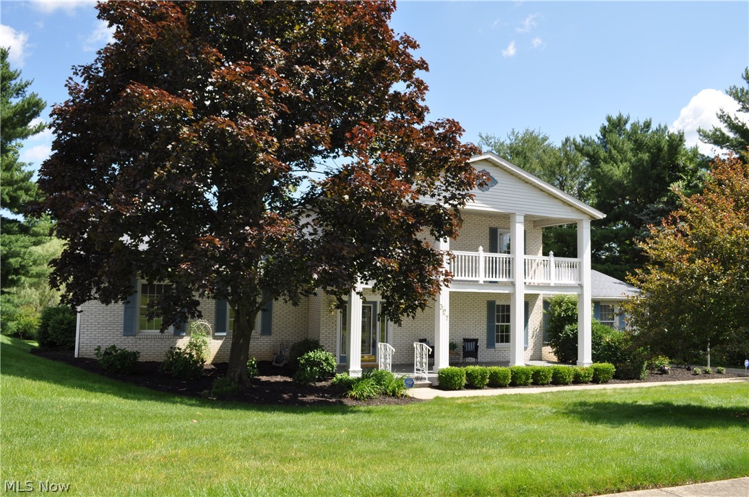 Welcome to this Georgian style, two story brick home, accented by symmetrical composition & formal classical details.  Over 2700 sq ft, that will pass the white glove test.  Every room has been freshly painted.  Inviting covered front porch leads to foyer, adorned with staircase & chandelier.  The garage is enhanced with nature stone flooring.  Newer tilt in vinyl windows.  High efficient furnace.  First floor laundry which includes the washer & dryer.  There is also a built in safe.  Finished lower level offers many perks, including kitchenette, wood burning stove and full bath.  All the rooms are generously sized.  Master en suite renders double sinks, linen closet, ceiling fan and plenty of closet space.  You'll enjoy your enclosed patio overlooking private setting.  The concrete driveway is also crisp, with no tripping hazards.  Beautifully landscaped with hydrangeas, drift roses and garden fresh mulch.  Schedule your showing today!