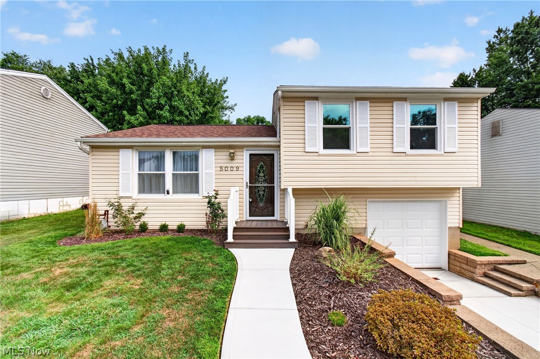 Having recently undergone a meticulous renovation, this Perry Township gem is ready for its next generation of owners! Brand-new luxury vinyl plank flooring greets you upon entry, while both bedrooms and both sets of stairs feature fresh new carpeting. The eat-in kitchen received the home's most dramatic transformation and now offers the ideal layout for cooking, entertaining, and everyday living. This chef's kitchen is complete with a new stainless steel gas range, spacious center island, stainless steel vent hood, new cabinetry, quartz countertops, and a timeless subway tile backsplash. Originally built as a three-bedroom home, the front two bedrooms were thoughtfully combined years ago into one larger, more versatile bedroom. This spacious layout is complemented by an updated full bath and a second generously sized bedroom at the rear of the home. The lower level offers a built-in storage area & laundry space that walks out to the attached garage as well as a spacious crawl space for additional storage. A newly installed central air conditioning system keeps the home comfortable, while brand-new second-story windows improve energy efficiency and insulation. The rear sliding glass door, complete with between-the-glass blinds, opens to a covered concrete patio overlooking the fully fenced backyard with a storage shed. The updates don't stop there! This home also features a brand-new roof, concrete driveway, and sidewalks, giving you peace of mind for years to come. The only thing left to do is move in—but first, you'll have to make it yours! Call your favorite Realtor today to schedule your private showing.