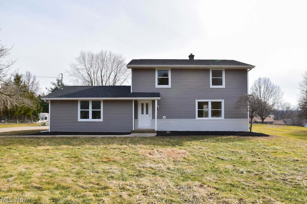 Completely remodeled 4 bedroom colonial with a 3-car garage on nearly half an acre! Lovely curb appeal with brand new siding and windows. This bright, inviting home offers spacious living areas with new flooring and fresh paint throughout. Find your culinary inspiration in the beautiful kitchen with new white cabinets, subway tile backsplash, stainless steel appliances, a breakfast bar and a pantry. The kitchen opens to the dinette with sliding doors to the back patio. Gather in the huge, sun-filled living room or cozy up next to the fireplace in the massive family room addition. Convenient half bath on the main level, too. Upstairs, there are 4 bedrooms and an updated full bath with a linen closet and new vanity. Need even more space!? The lower level offers a finished rec room that boasts a gorgeous dry bar. This is the perfect entertaining area! The unfinished side provides lots of storage as well as a new furnace and hot water tank. Fantastic backyard with a patio to enjoy the summ