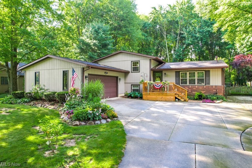 **Open House that was scheduled for 9/3 at 12pm is CANCELLED* Enchanting 3 Bed/2 Bath spacious split-level home minutes away from KSU and NEOMED! The main level features wood-look laminate flooring, a formal living room, an eat-in kitchen with stainless steel appliances, beverage center, farmhouse sink, Quartz countertops, ceramic tile backsplash & a Great Room full of rustic touches such as wood beams & a woodburning stove that are reminiscent of a warm and cozy lodge. Head upstairs to the second level where you will find three carpeted bedrooms & a full bath w/access from both the hall & Master. Down a few steps to the lower level is a family room featuring a brick gas fireplace, laminate wood-look flooring, a 2nd full bath & laundry room with washer/dryer that remain with the home. Down another level to the basement is a large carpeted rec room. You'll never want to leave this charming home with its lush and private backyard space! Entertain your guests on the covered patio which ca