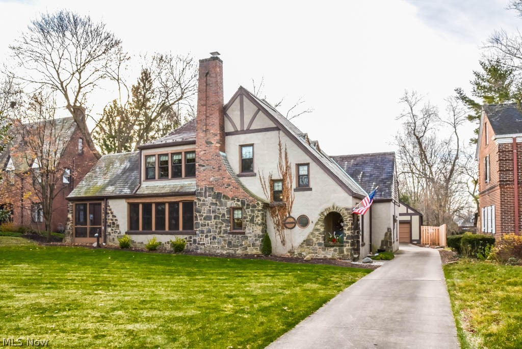 Exquisite Tudor-style home packed with charming attributes in historic Ridgewood! In the past 6 months, every inch has been cleaned, new plaster on walls/ceiling, professionally refinished hardwood floors and fresh paint all while retaining the desired charm of this 1920's house. They don't make them like this anymore - built-ins everywhere that are gorgeous as well as convenient, a laundry chute, Dutch door, solid doors throughout and more! Welcoming entryway with bench seating, a mail slot and storage under the stairs. Beautifully remodeled kitchen has granite countertops, stainless steel dishwasher/oven, a serving window to the dining room and Schrock cabinets featuring spice racks and pull out drawers. Spacious formal dining room and living room boasting a gas fireplace, bench seating and built-in bookshelves. Access to the screened-in porch, too. Heading upstairs, the landing is lined with bookshelves - a great at-home library! All 4 bedrooms have hardwood floors and ceiling fans.