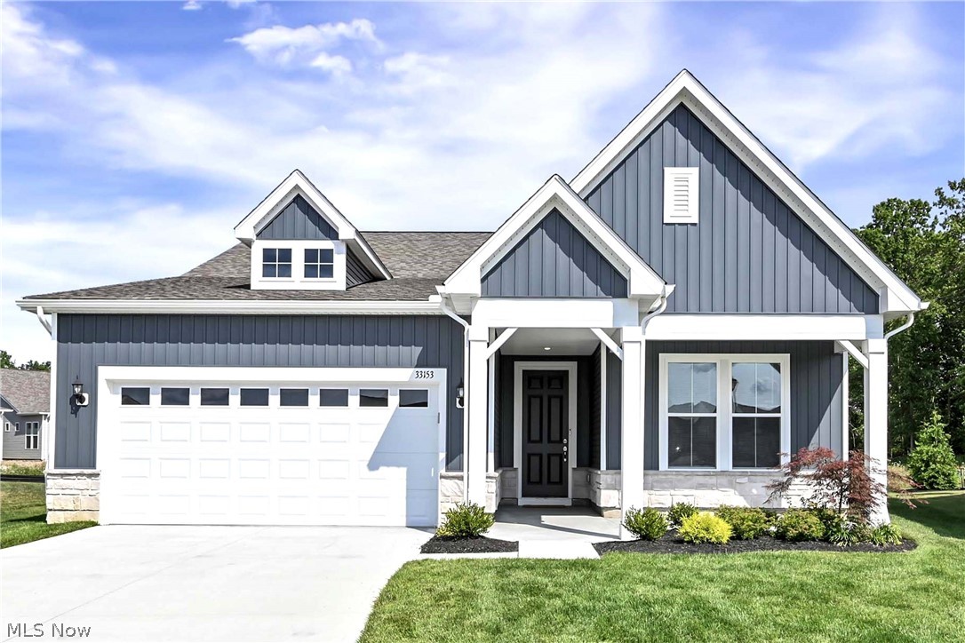 Prepare to be moved! Welcome to 33153 Coastal Drive, a beautifully upgraded ranch built in 2025, offering 1,841 square feet of thoughtfully designed, single-level living on a premium lot in Avon Lake's sought-after Port West community. This move-in-ready home showcases extensive builder upgrades, including luxury vinyl tile flooring throughout, a cozy gas fireplace, covered rear patio, upgraded lighting package, first-floor laundry, a custom built-in boot bench in the mudroom, and much more. Step inside to an open, light-filled floor plan where luxury vinyl flooring flows throughout. Just off the foyer, double doors lead to a bright and versatile home office—perfect for working remotely, hobbies, or a quiet reading space. The spacious great room features a gas fireplace and oversized windows that fill the home with natural light. It opens seamlessly to the gourmet kitchen, complete with an upgraded spacious layout, large center island, enhanced cabinetry, gleaming quartz countertops, custom tile backsplash, stylish pendant lighting, upgraded sink and faucet, and Whirlpool appliances. The adjoining dining area offers direct access to the covered patio, creating an ideal space for indoor-outdoor entertaining. The private primary suite features a generous walk-in closet and a beautifully appointed ensuite bath with dual vanities and a glass-enclosed walk-in shower. A second bedroom, full guest bath, first-floor laundry room and mudroom complete the home's well-designed layout. Outside, enjoy a fully fenced backyard with a sprinkler system, newly installed sod, professional landscaping, and a covered patio perfect for relaxing or entertaining. Residents of Port West also enjoy an outdoor swimming pool. Completing the home is an oversized three-car attached garage, offering ample room for vehicles or extra storage. Combining today's most desirable finishes with low-maintenance living, this exceptional home is better than new and ready for its next owner.