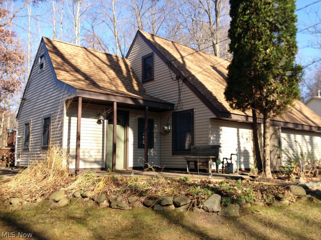 Look at this rare find! Cabin like feel with a private wooded lot. Almost everything inside and out has been remodeled or updated. New flooring throughout, new kitchen with all new appliances, new updated bathrooms, new roof(2012) & new siding(2014). The home has an open floorplan featuring a wood pellet stove in the dining room, a fireplace in the living room and an open modern staircase with an skylight above and opens to the vaulted ceiling. Upstairs bedrooms have vaulted ceilings with open rafters for a one of a kind look. Master bedroom walks out on to the back deck and to the swimming pool.  2 car attached garage + 2 car detached garage/barn with 2nd story. Perfect house for entertaining. Plenty of parking on the driveway leading to the detached garage. Everything is done so get ready to relax and enjoy. Don't miss your opportunity to own this great home. Call today to schedule your showing!